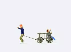 Bambini con un carretto di legno